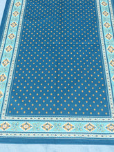 Load image into Gallery viewer, Acrylic coating allows for universal wipe clean finish, allowing for liquids and oils to bead off. Measures 16.5 by 60 in. Pictured on a 72 inch length table for reference, but may be draped over the sides of a smaller table as well. Manufactured by l'Ensoillade and made in France. Pictured in jade with light turquoise and yellow accents