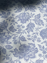 Load image into Gallery viewer, Anti-stain teflon treatment allows for liquids to bead off and universal wipe clean finish allows for liquids and oils to bead off. Measures 20.5 by 58 in. Pictured on a 72 inch length table for reference, but may be draped over the sides of a smaller table as well. Pictured in caprice blue featuring jacquard woven pomegranate-like baroque floral blooms and beautifully detailed leaves and bouquets of intertwined branching elaborated fleur de lys.