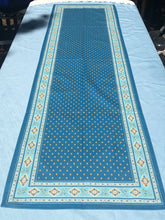 Load image into Gallery viewer, Acrylic coating allows for universal wipe clean finish, allowing for liquids and oils to bead off. Measures 16.5 by 60 in. Pictured on a 72 inch length table for reference, but may be draped over the sides of a smaller table as well. Manufactured by l'Ensoillade and made in France. Pictured in jade