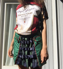 Load image into Gallery viewer, dirndle back multi navy satin bow ruched plaid taffeta upcycled chruistmas napkin waist cuffed pleat flounce school uniform skirt great for holiday winter parties or camp cosplay fashion. Upcycled Christmas nakins are a grid of dark evergreen with bright red woven edges.