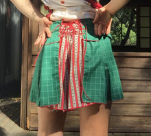Load image into Gallery viewer, dirndle back multi navy satin bow ruched plaid taffeta upcycled chruistmas napkin waist cuffed pleat flounce school uniform skirt great for holiday winter parties or camp cosplay fashion. Upcycled Christmas nakins are a grid of dark evergreen with bright red woven edges.