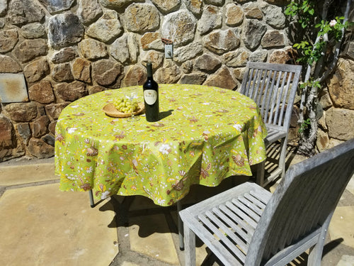 Measuring 62 inches across with a traditional provence floral fall evocative harvest motif featuring hues of yellow and brown, this chartreuse color roundcut cotton tablecloth is coated with acrylic for a wipe clean finish. Made by Le Cluny, imported from France.