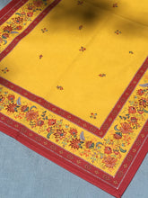 Load image into Gallery viewer, Anti stain wipe clean finish allows for liquids and oils to bead off. Measures 16.5 by 60 in. Pictured on a 72 inch length table for reference, but may be draped over the sides of a smaller table as well. Border color is red and background is yellow with multicolor provincial flora.
